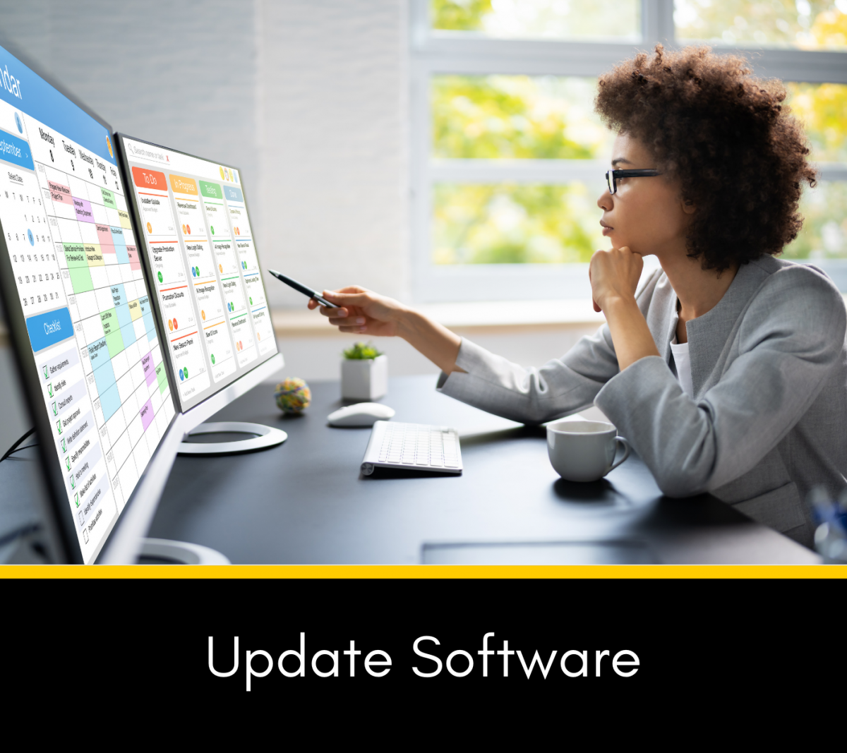 Picture of woman with dual monitors looking at them with a pen to follow along with the words Update Software