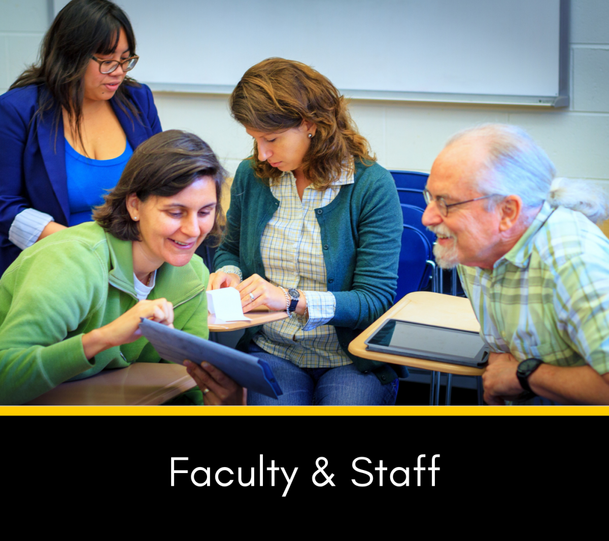 Faculty and staff collaborating at desks with tablets