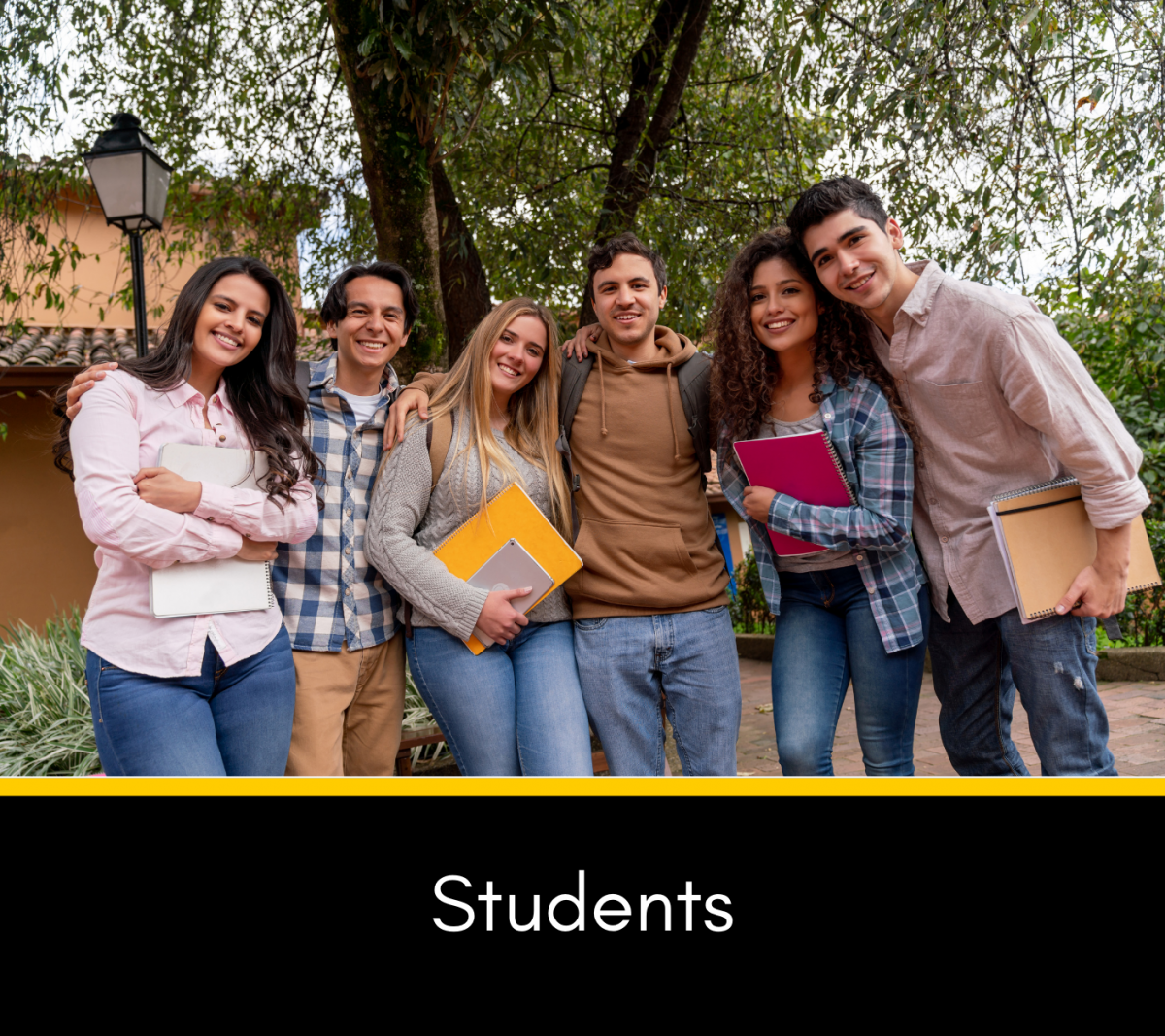 College students posing together outside with backpacks and notebooks