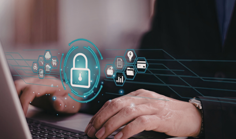 Hands typing on a laptop with symbols of a lock hovering over it