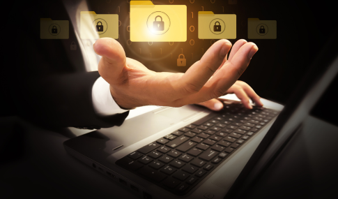 Image of a person's hands at a laptop looking like they're holding floating files with locks on them