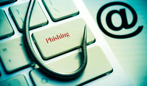 Image of a fish hook over a keyboard that says Phishing on the enter button, with the word Phishing