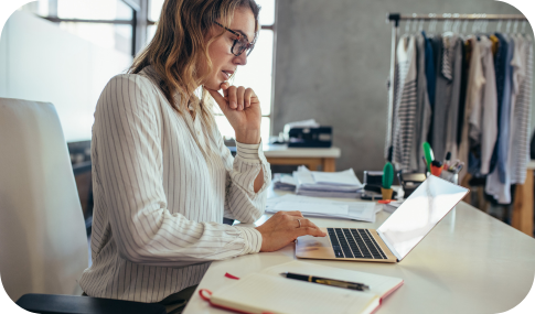 Image of a woman working on her laptop at a desk