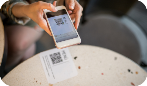 Hand holding a cellphone while scanning a QR code