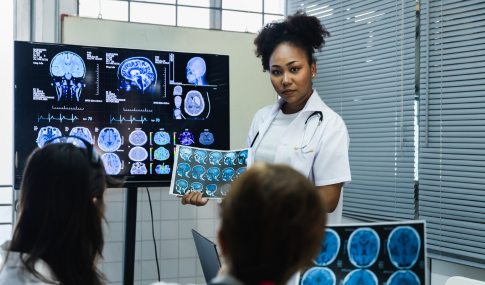 Medical professionals looking at medical images of a brain