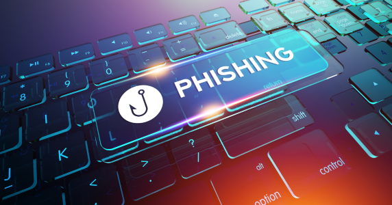 Keyboard with the word PHISHING and a phishing hook over the top of it