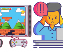 Man with head in hands at a desk in front of laptop with a video game image next to him